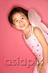 AsiaPix - Young girl in pink dress with artificial wings, smiling at camera