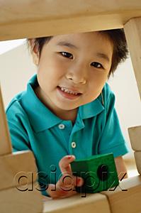 AsiaPix - Young girl with building blocks, looking at camera