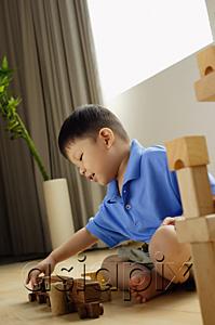 AsiaPix - Boy playing with toy train