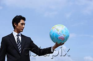 AsiaPix - Businessman holding globe, arms outstretched