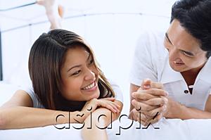 AsiaPix - Couple on bed, looking at each other