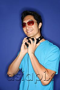 AsiaPix - Man wearing sunglasses, headphones around his neck