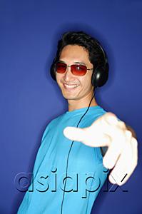 AsiaPix - Man wearing sunglasses, wearing headphones, hand outstretched