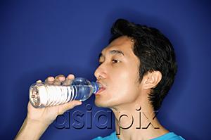 AsiaPix - Man drinking water from bottle