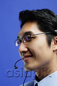 AsiaPix - Man wearing headset, looking away, smiling