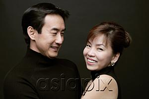 AsiaPix - Couple together, woman smiling at camera, man watching her