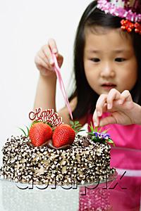 AsiaPix - Girl touching birthday cake