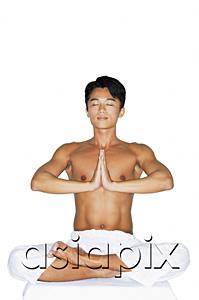AsiaPix - Man practicing yoga, hands together