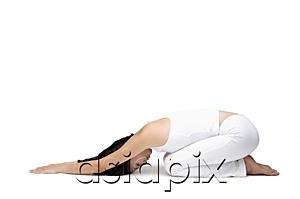 AsiaPix - Woman kneeling on floor, doing yoga