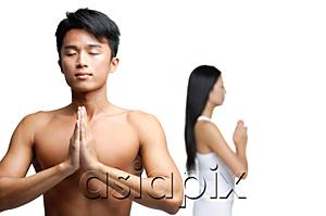 AsiaPix - Couple doing yoga, hands together, man facing camera, woman facing away