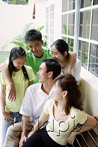 AsiaPix - Family looking at each other and smiling