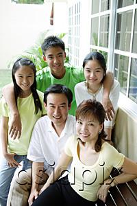 AsiaPix - Family looking at camera and smiling