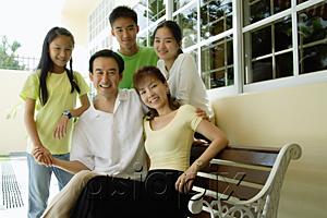 AsiaPix - Family with three children, smiling at camera