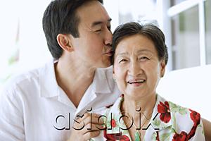AsiaPix - Mother and adult son together, son giving mother a kiss