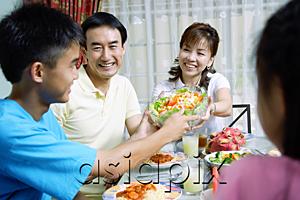 AsiaPix - Mother passing food to family members