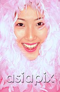 AsiaPix - Womans smiling face surrounded by feathers