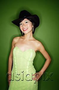 AsiaPix - Woman in green dress, wearing cowboy hat and earrings, smiling at camera