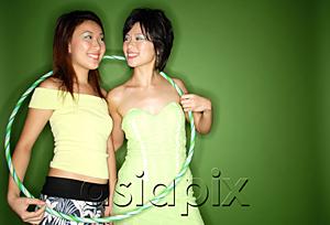 AsiaPix - Two women standing side by side, hoola hoop around them