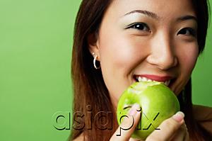 AsiaPix - Woman eating green apple