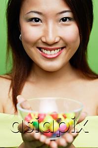 AsiaPix - Woman holding a bowl of candy