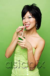 AsiaPix - Woman drinking from glass with straw
