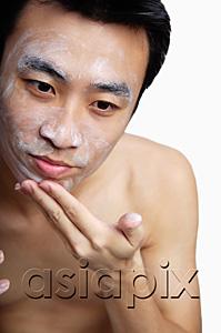 AsiaPix - Man cleansing face