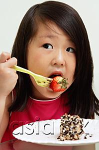 AsiaPix - Young girl eating strawberry with fork