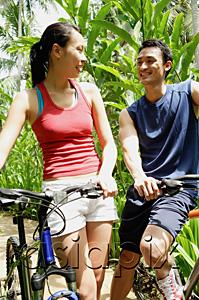 AsiaPix - Couple with bikes, smiling at each other