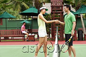 AsiaPix - Man and woman shaking hands across tennis court