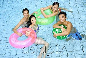 AsiaPix - Couples in swimming pool with floats looking at camera