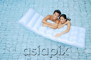 AsiaPix - Couple in swimming pool leaning on pool raft