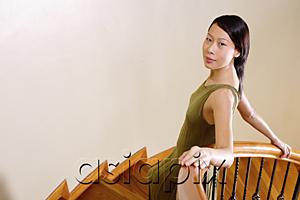 AsiaPix - Woman leaning on staircase, looking at camera