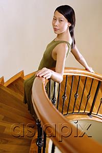 AsiaPix - Woman leaning on staircase, looking at camera, portrait