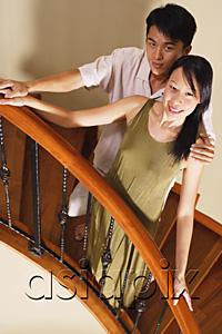 AsiaPix - Couple standing on staircase, smiling at camera