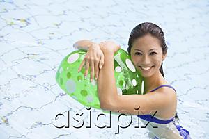 AsiaPix - Woman in swimming pool, hugging beach ball