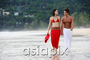 AsiaPix - Couple walking side by side along beach