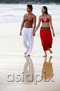 AsiaPix - Couple walking side by side along beach, holding hands, looking away