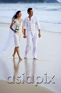 AsiaPix - Bride and groom walking on beach, holding hands