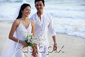 AsiaPix - Bride and groom walking on beach, smiling