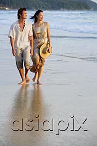 AsiaPix - Couple walking on beach, looking away