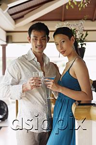 AsiaPix - Couple standing side by side, holding drinks, looking at camera