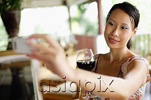 AsiaPix - Woman holding mobile phone, taking photograph