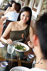 AsiaPix - Couple having a meal in restaurant, woman smiling