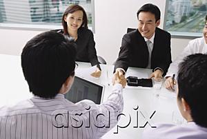 AsiaPix - Businessmen in meeting, shaking hands across table