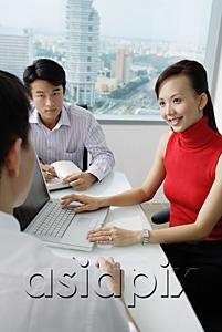 AsiaPix - Executives having a discussion, woman using laptop