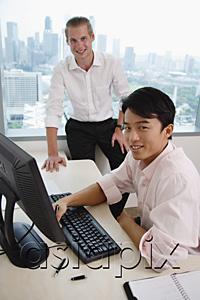 AsiaPix - Asian and Caucasian executive in office, looking at camera