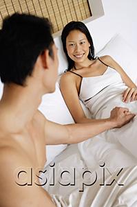 AsiaPix - Couple in bed, man holding womans hand