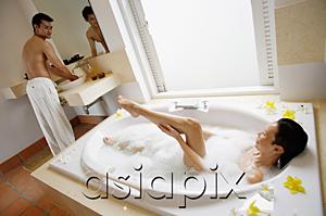 AsiaPix - Couple in bathroom, woman in bath, washing leg, man standing at sink, turning to look at her