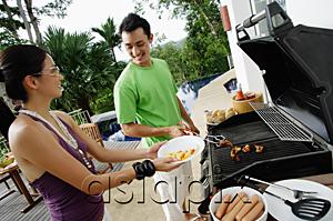 AsiaPix - Couple grilling food on barbeque