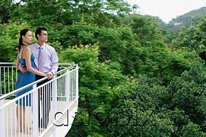 AsiaPix - Couple standing on balcony, looking away
